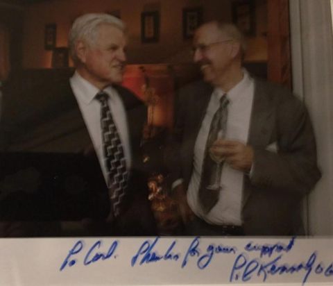 Senator Edward M. Kennedy standing beside Carl W. Rausch, with a handwritten dedication beneath the historical photograph shared by BHOC Therapeutics.
